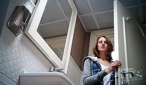 Подглядывают в туалете за девушкой с рыжеватыми волосами