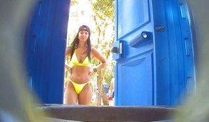 Девушка на пляже зашла пописать в биотуалет